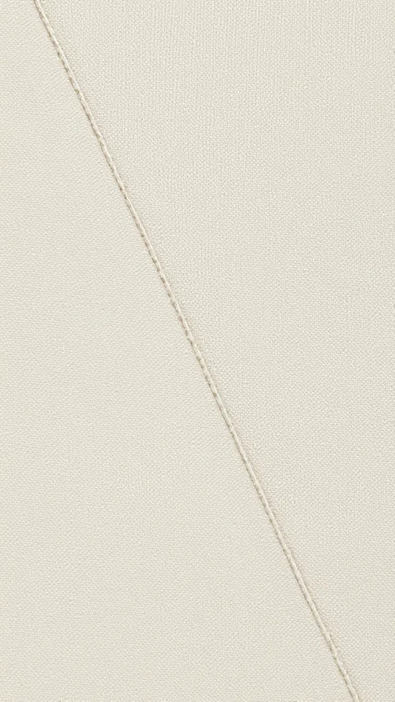 Closeup of pressed fabric edge along seam line with thread detail